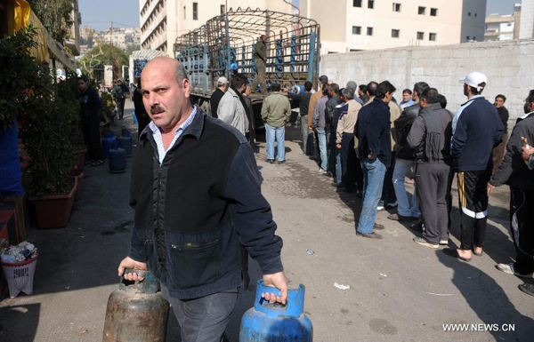 Residents queue up to get gas cylinders at a gas station in Damascus, capital of Syria, on Nov. 27, 2011. Syrians have been suffering from the shortage of cooking gas, due to the months of unrest and economic sanctions imposed by Europe and the United States. 